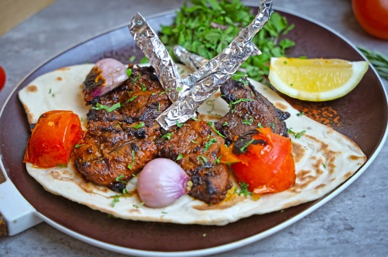 A savory flatbread topped with tender lamb meat and fresh vegetables